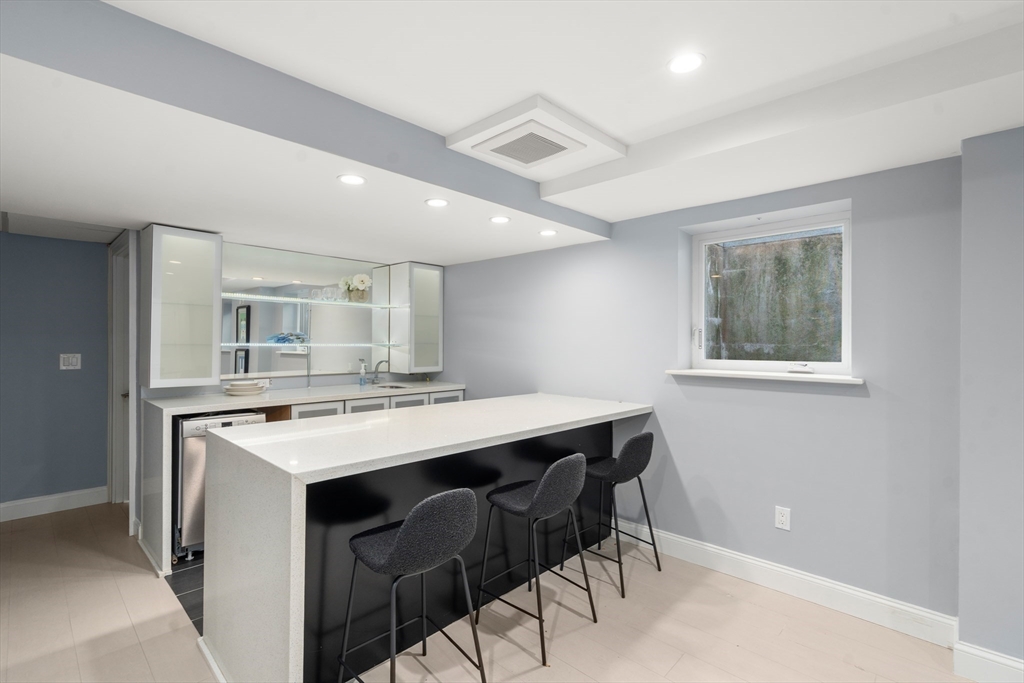 152 Bellevue Road Watertown, MA 02472 - Photo 30 of 42 a kitchen with a stove a table and chairs