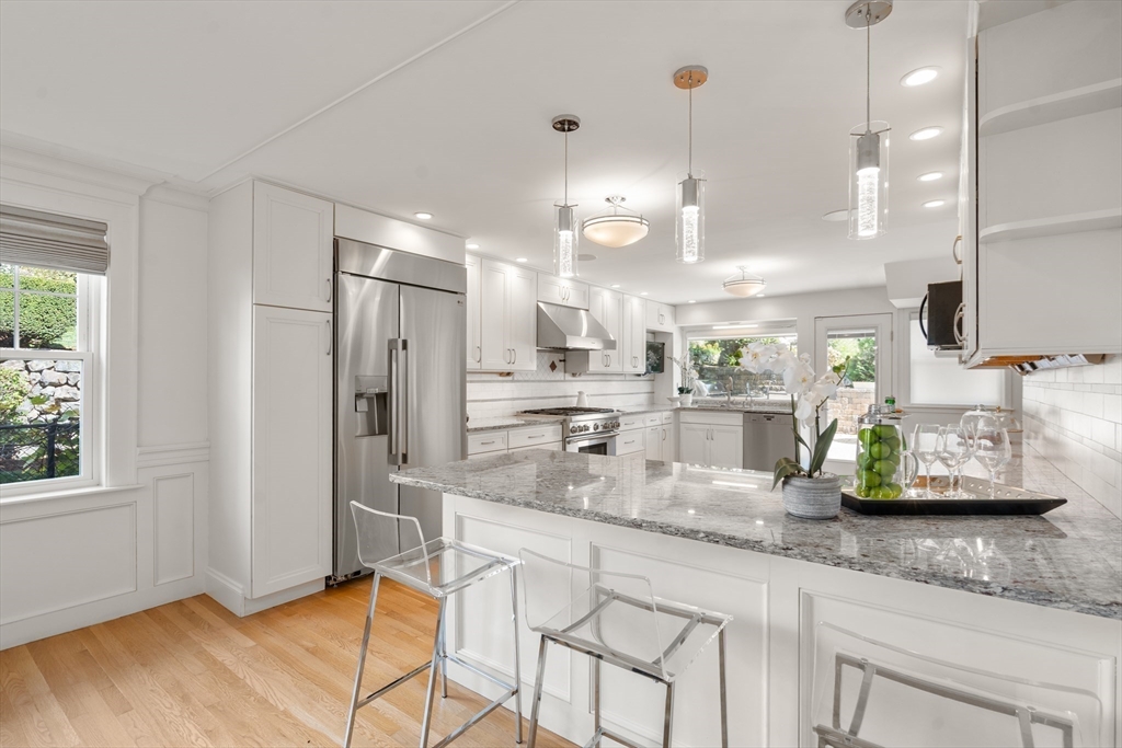 152 Bellevue Road Watertown, MA 02472 - Photo 8 of 42 a kitchen with stainless steel appliances granite countertop a sink a refrigerator and a counter top space