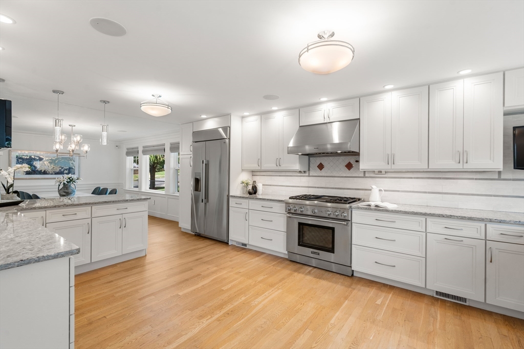 152 Bellevue Road Watertown, MA 02472 - Photo 10 of 42 a large kitchen with cabinets wooden floor and stainless steel appliances