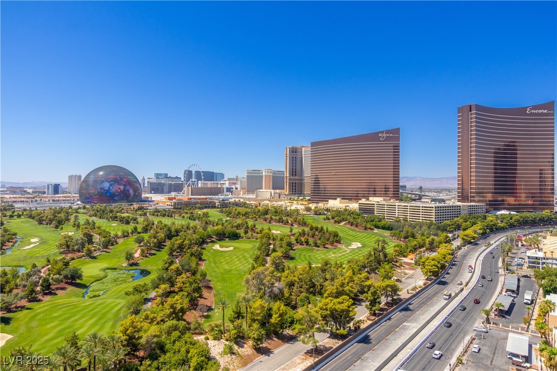 View of urban area with a local golf course and a large body of water