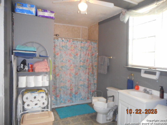 1212 Magnolia Street Jourdanton, TX 78026 - Photo 12 of 14 a bathroom with a sink toilet and shower