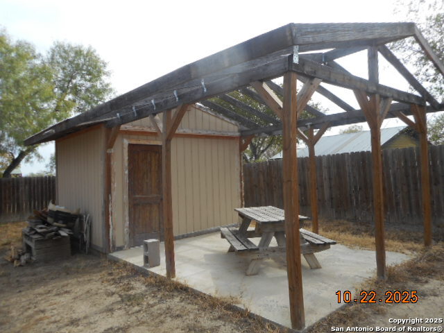 1212 Magnolia Street Jourdanton, TX 78026 - Photo 14 of 14 a backyard of a house with table and chairs