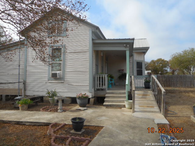 1212 Magnolia Street Jourdanton, TX 78026 - Photo 3 of 14 a view of a house with backyard and sitting area