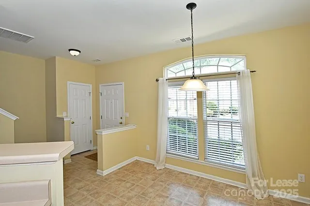 a view of a room with window and entryway