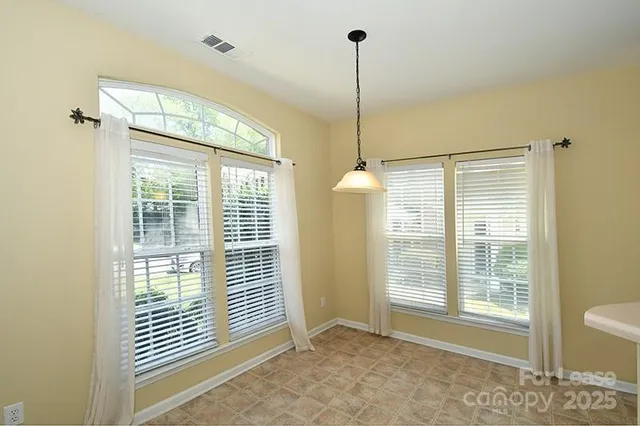 a view of an empty room with windows