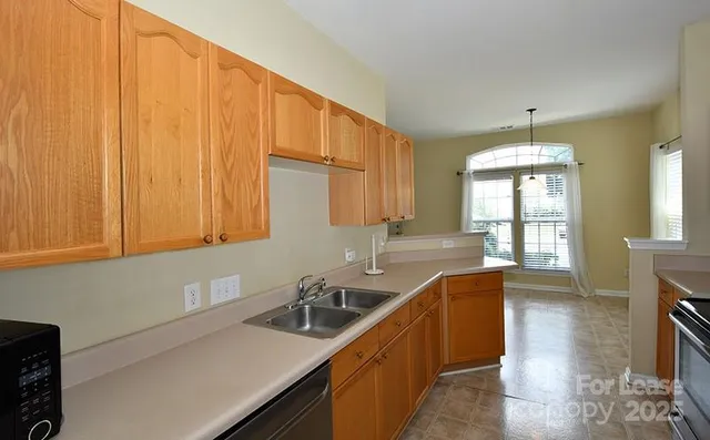 a kitchen with a sink and a window