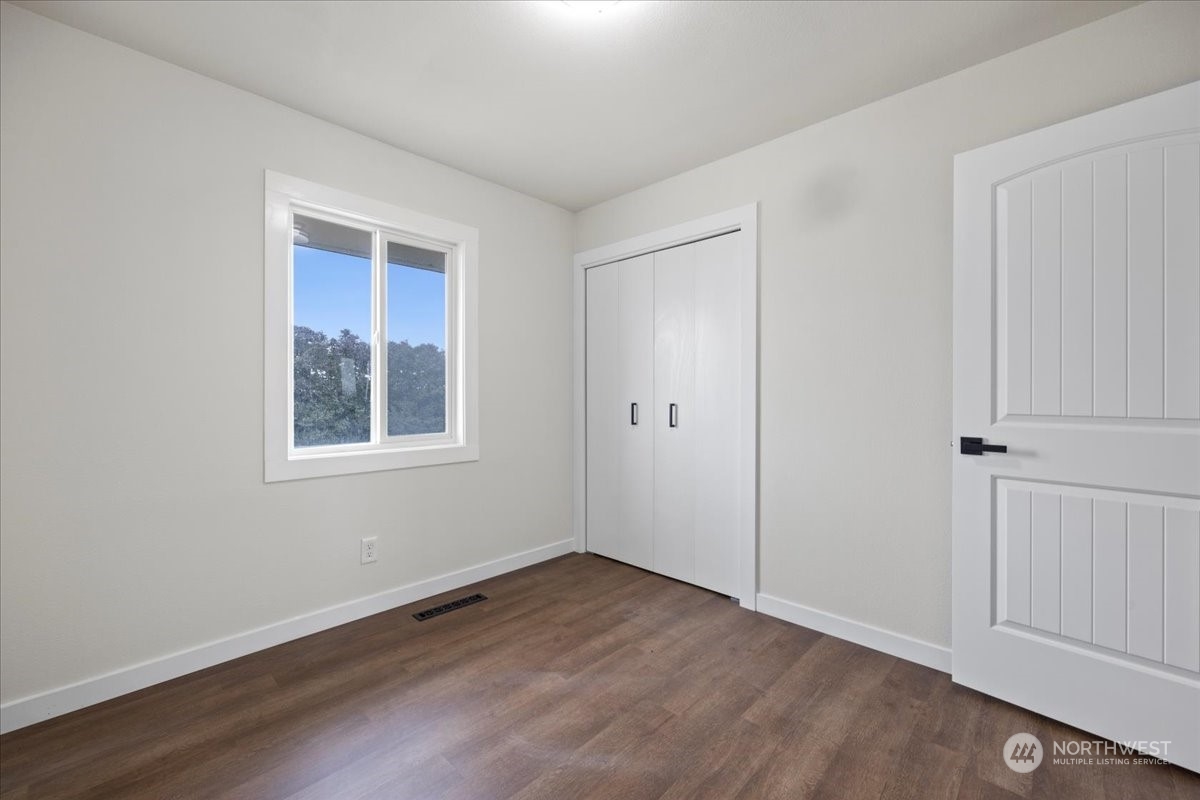 465 South Lemaster Road Othello, WA 99344 - Photo 25 of 40 a view of an empty room with wooden floor and a window