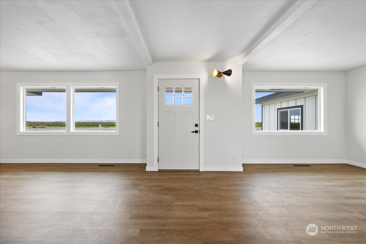 465 South Lemaster Road Othello, WA 99344 - Photo 8 of 40 a view of an empty room with wooden floor and a window
