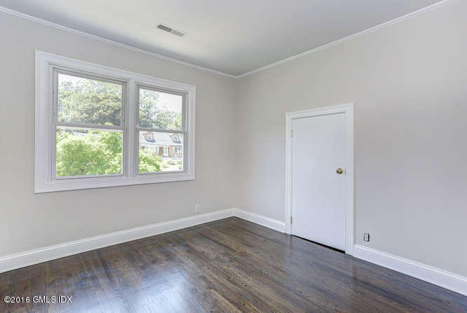 5 Carol Place Riverside, CT 06878 - Photo 19 of 25 an empty room with wooden floor and windows
