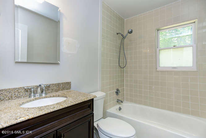 5 Carol Place Riverside, CT 06878 - Photo 20 of 25 a bathroom with a granite countertop sink toilet and shower