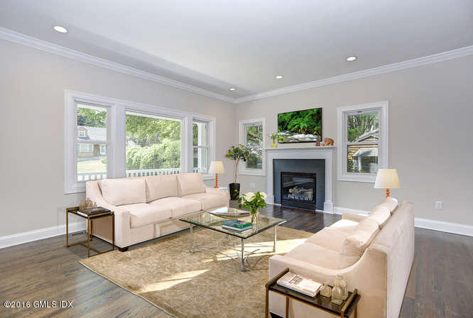 5 Carol Place Riverside, CT 06878 - Photo 2 of 25 a living room with furniture a flat screen tv and a fireplace