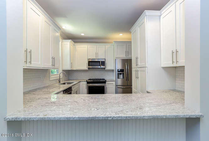 5 Carol Place Riverside, CT 06878 - Photo 7 of 25 a kitchen with granite countertop a sink a stove and cabinets