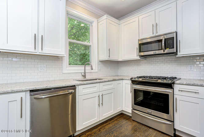 5 Carol Place Riverside, CT 06878 - Photo 8 of 25 a kitchen with white cabinets stainless steel appliances and sink