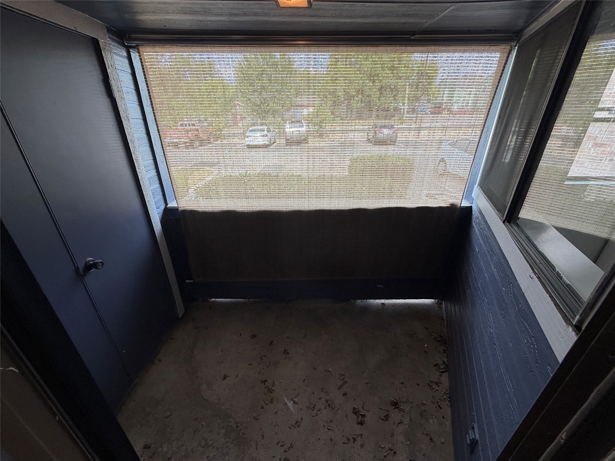 2500 Burleson Road, Unit 209 Austin, TX 78741 - Photo 10 of 15 Concrete flooring and dark wood paneling define this covered outdoor balcony space.