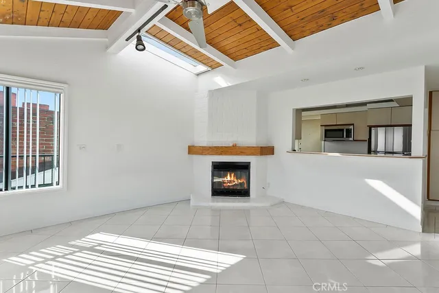a view of a livingroom with a fireplace and window
