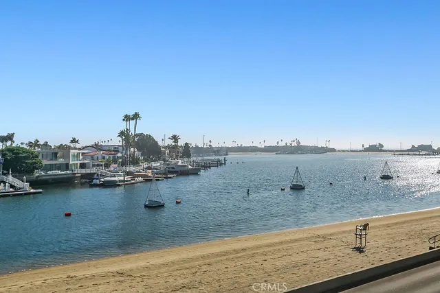 a view of a livingroom with wooden floor and a fireplace