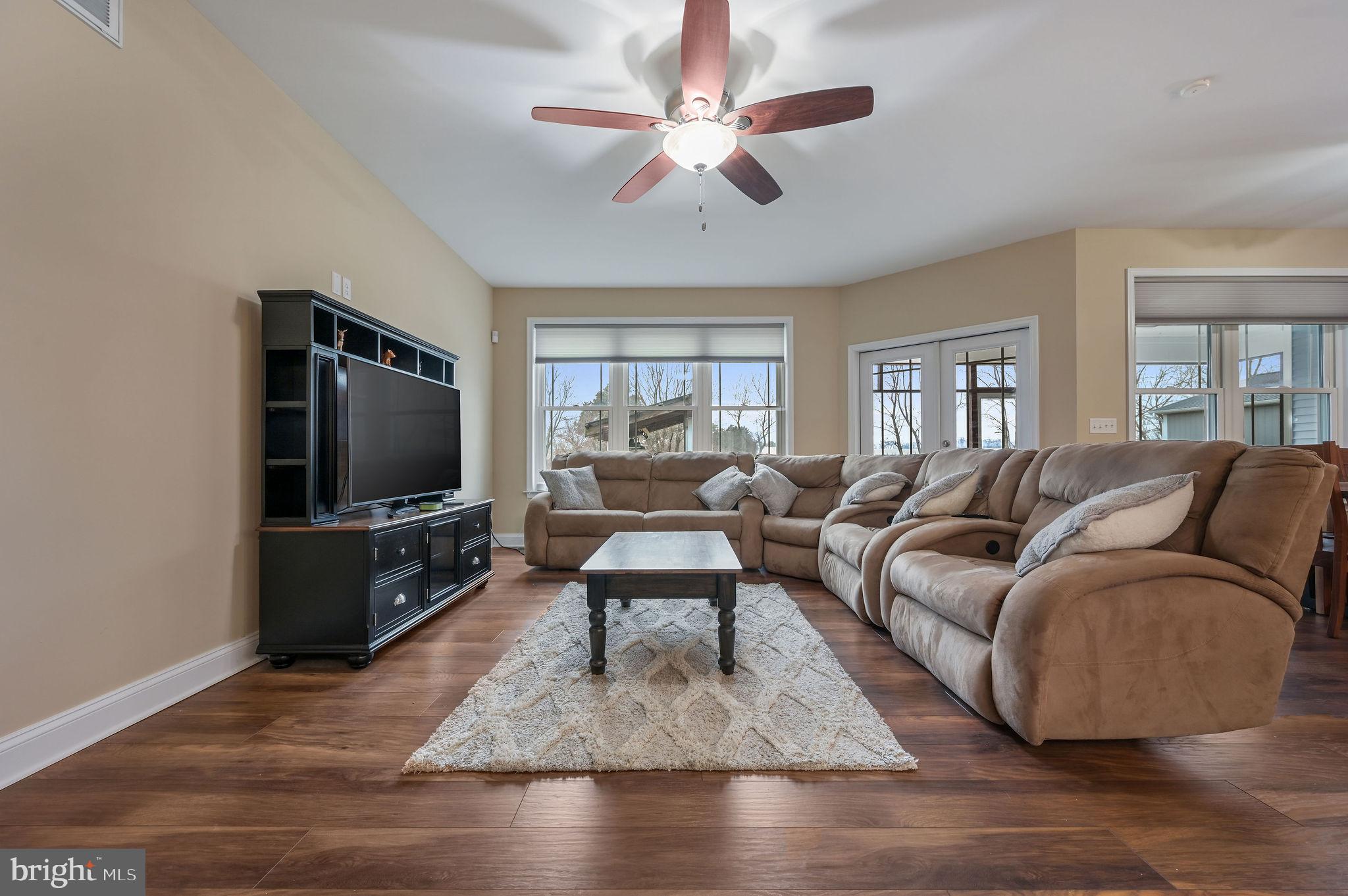 321 Blue Heron Road Dover, DE 19904 - Photo 12 of 47 a living room with furniture a flat screen tv and a large window
