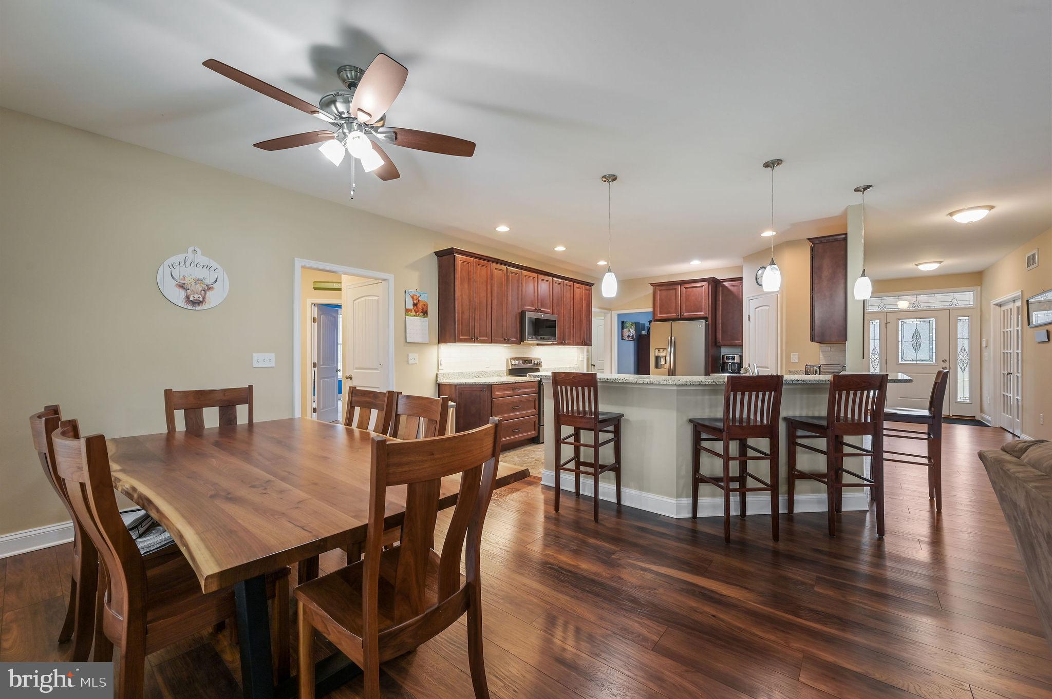 321 Blue Heron Road Dover, DE 19904 - Photo 18 of 47 a view of a dining room with furniture and wooden floor