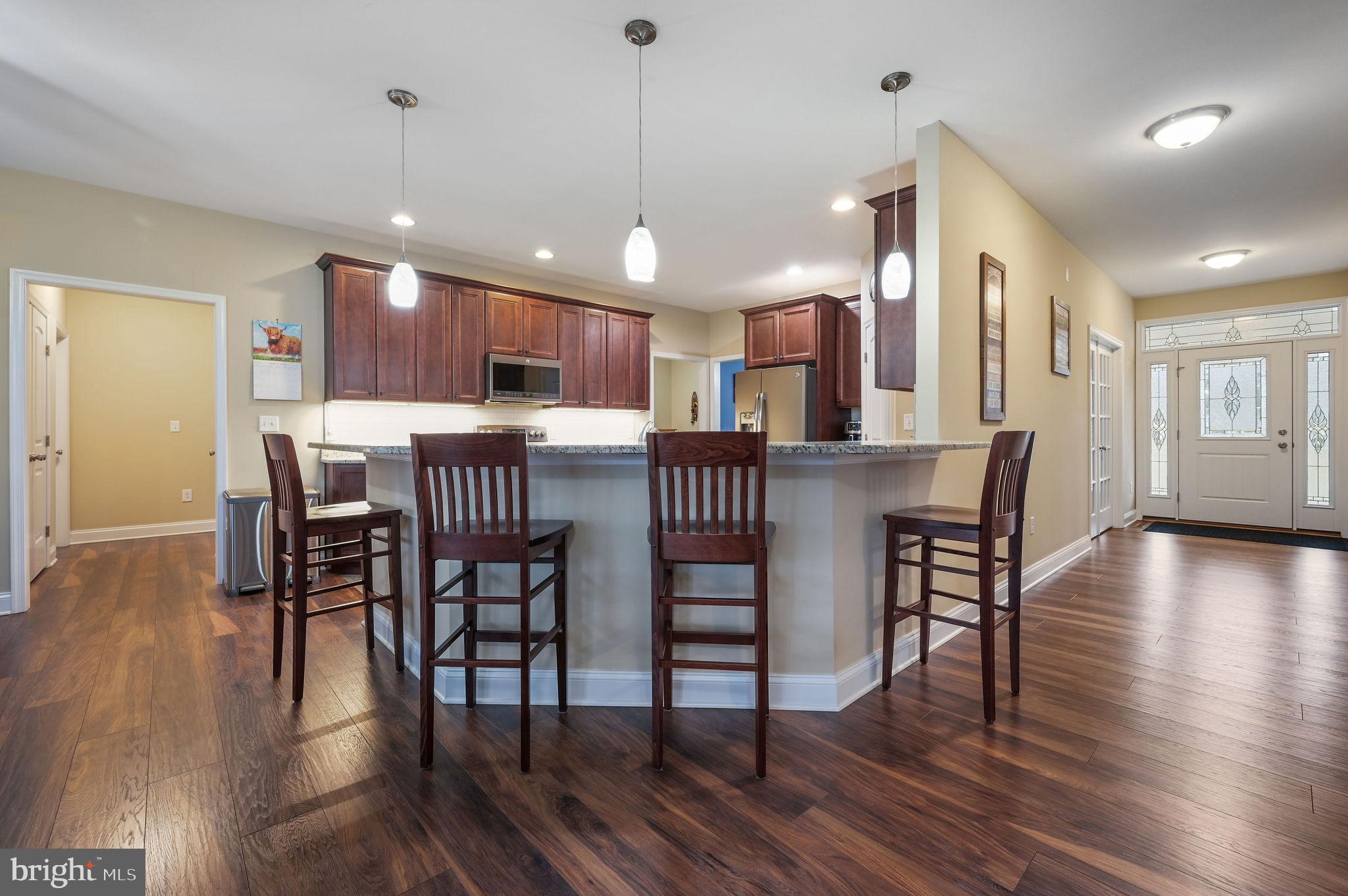 321 Blue Heron Road Dover, DE 19904 - Photo 20 of 47 a view of a dining room with furniture and wooden floor