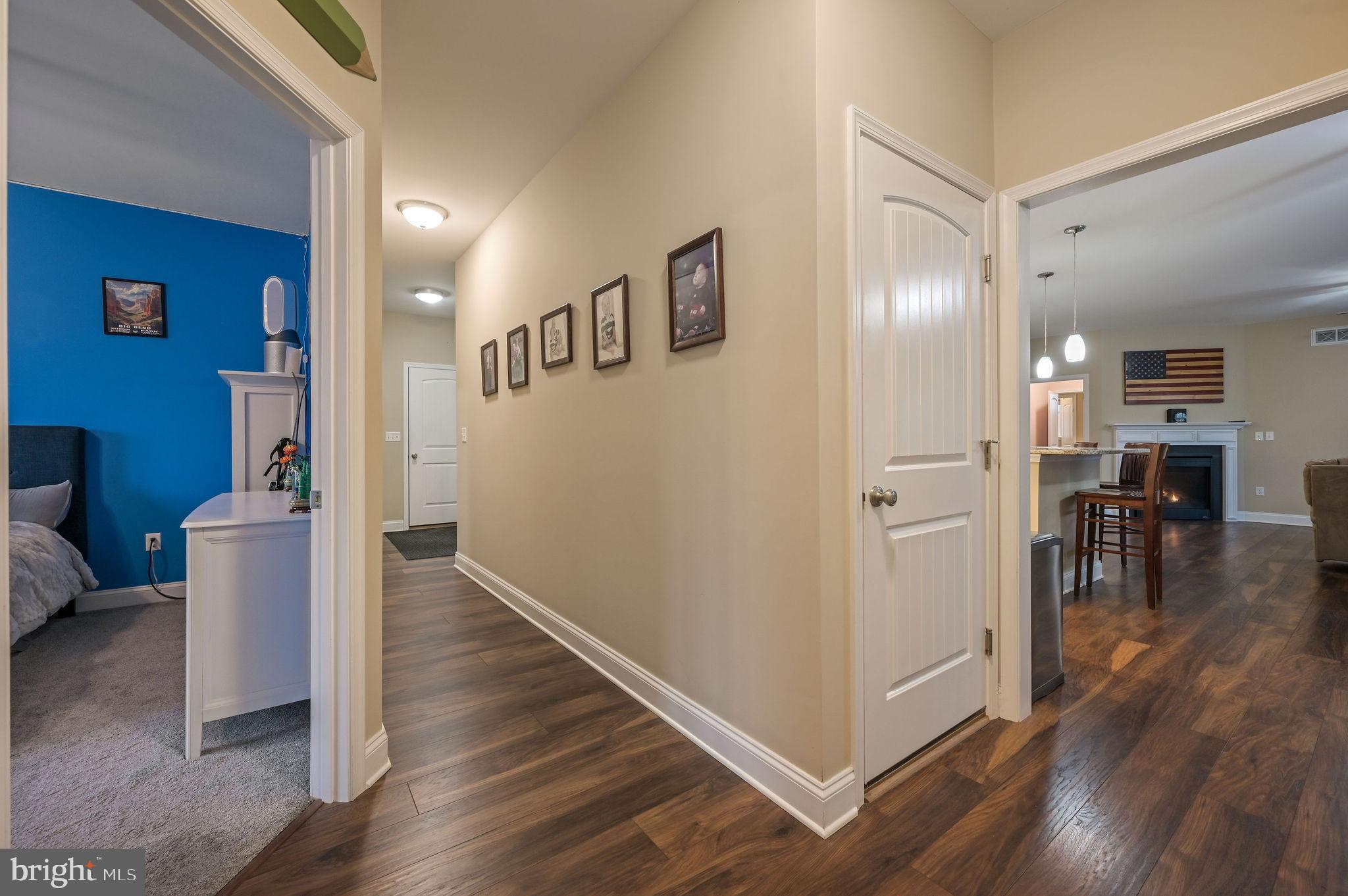 321 Blue Heron Road Dover, DE 19904 - Photo 26 of 47 a view of a hallway with dining room and wooden floor