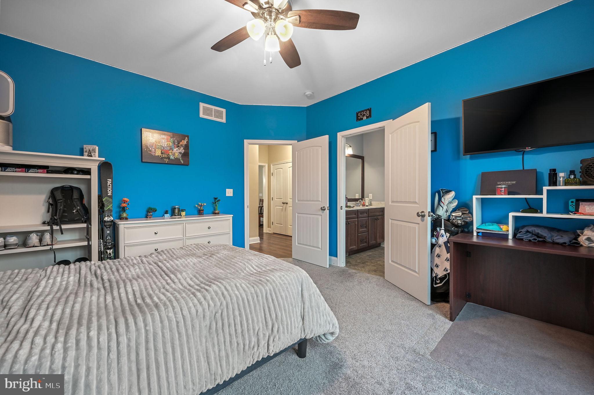 321 Blue Heron Road Dover, DE 19904 - Photo 34 of 47 a bedroom with a bed and a flat screen tv