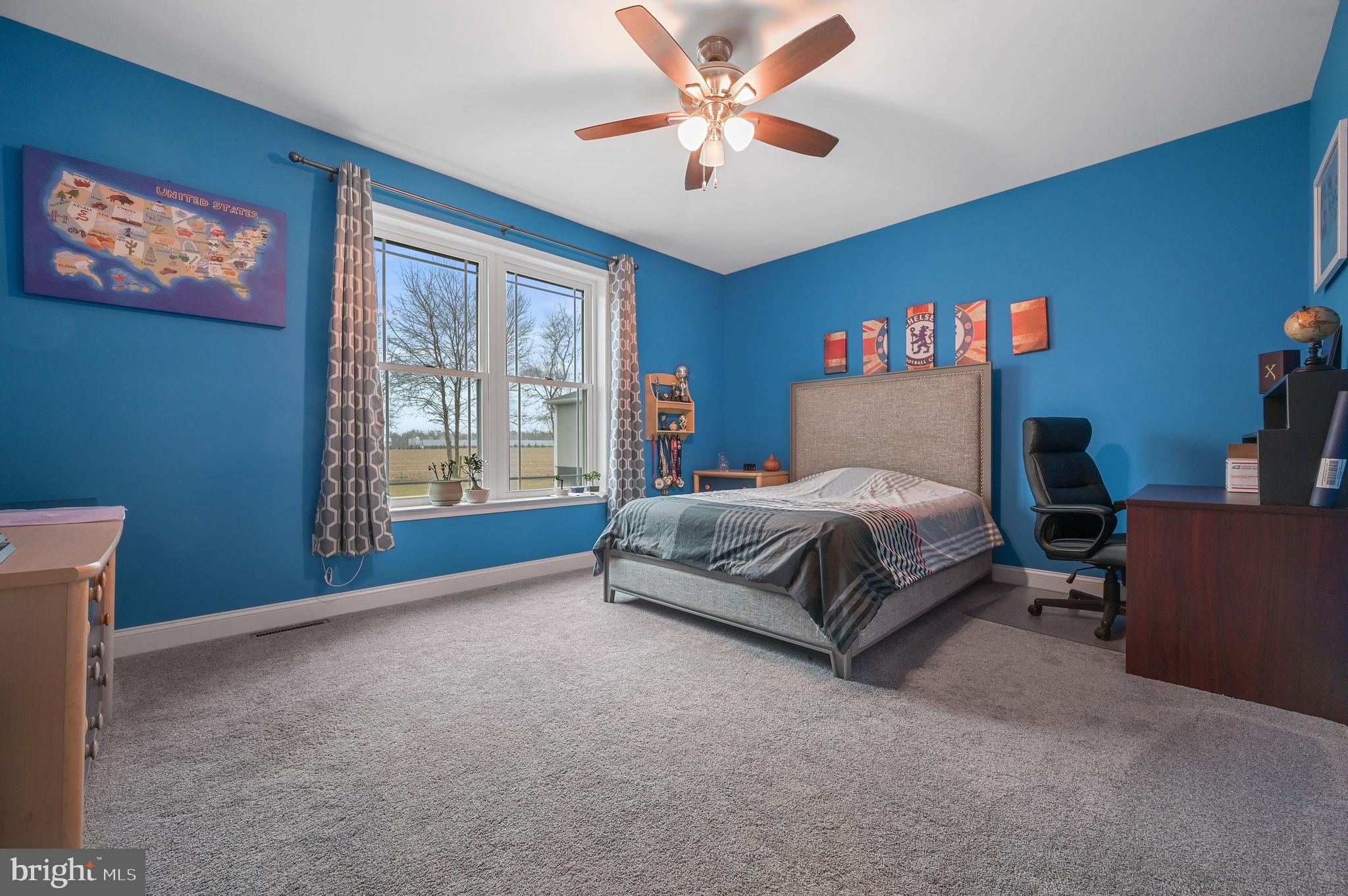 321 Blue Heron Road Dover, DE 19904 - Photo 35 of 47 a bedroom with a bed and a chandelier