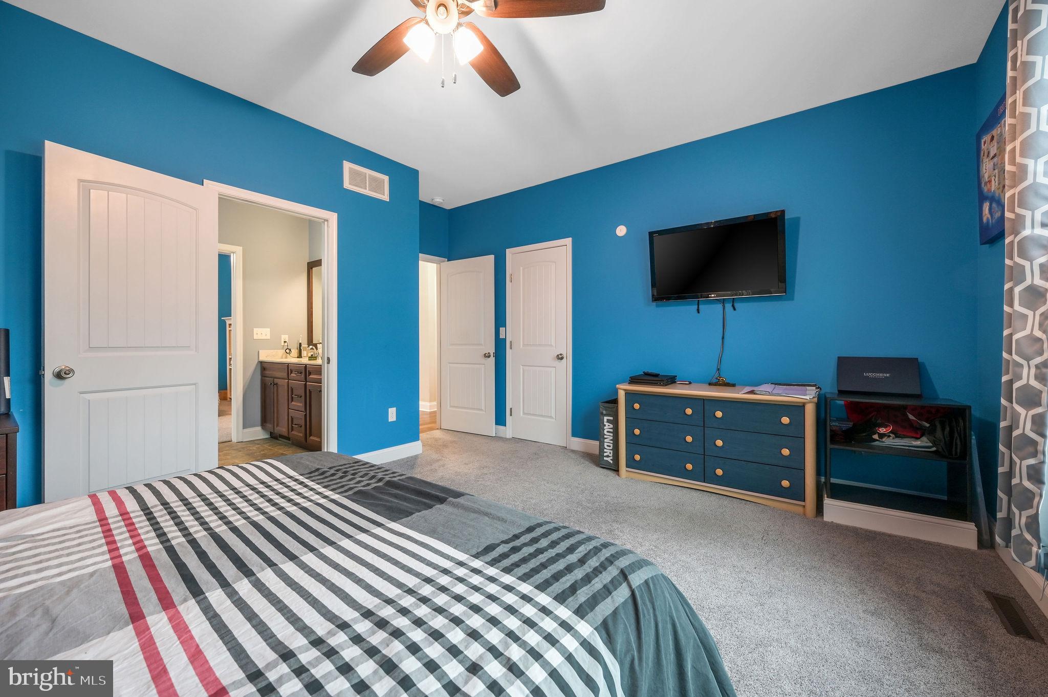 321 Blue Heron Road Dover, DE 19904 - Photo 36 of 47 a bedroom with a bed and a flat screen tv