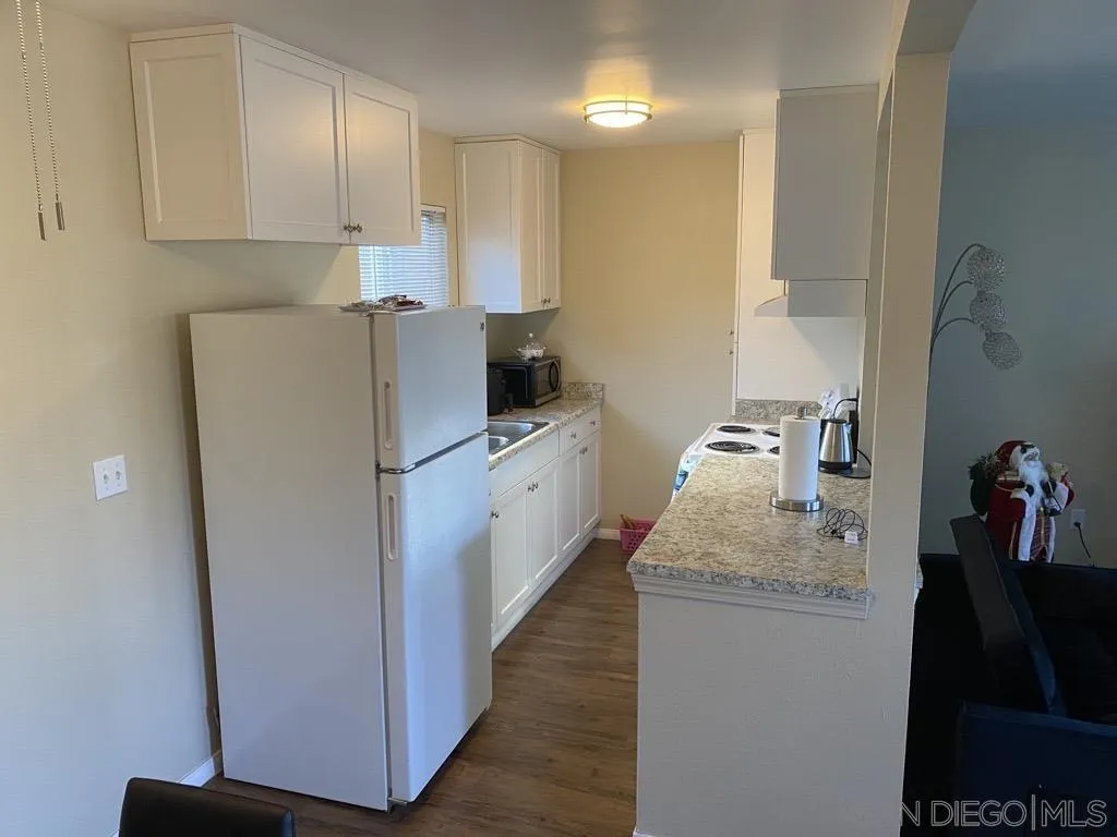 181 Ballantyne Street El Cajon, CA 92020 - Photo 12 of 13 a kitchen with sink a refrigerator and cabinets