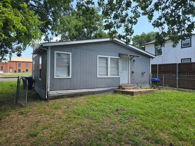 a view of a house with a yard and sitting area