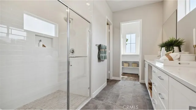a bathroom with a double vanity sink a mirror and a shower