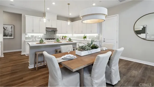 a dining room with furniture and wooden floor