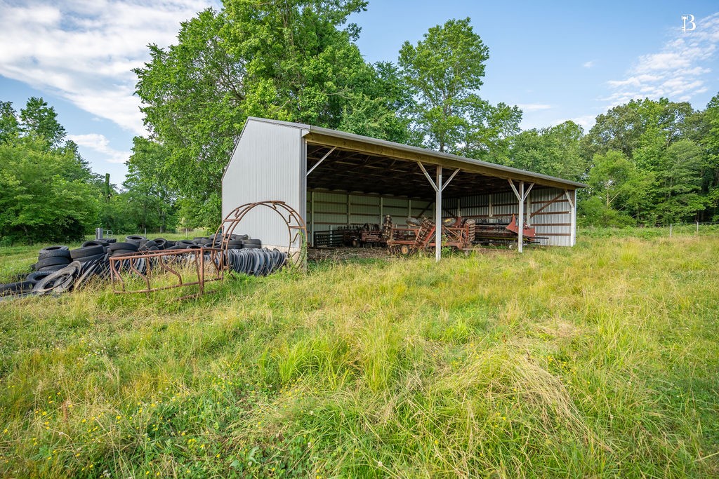 400 McIntosh Chapel Road Nortonville, KY 42442 - Photo 14 of 15 a backyard of a house with table and chairs