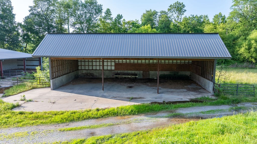 400 McIntosh Chapel Road Nortonville, KY 42442 - Photo 9 of 15 a backyard of a house with table and chairs