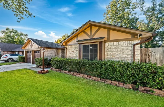 a front view of a house with garden