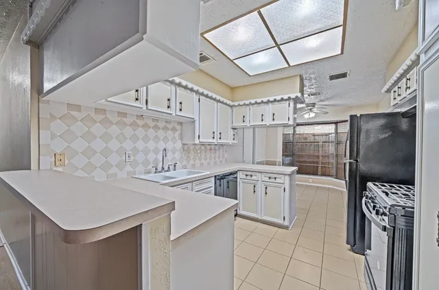 a kitchen with cabinets a sink and appliances