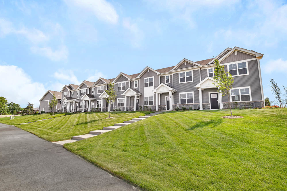 2253 Riesling Road Oswego, IL 60543 - Photo 2 of 27 a view of a big house with a big yard and large trees