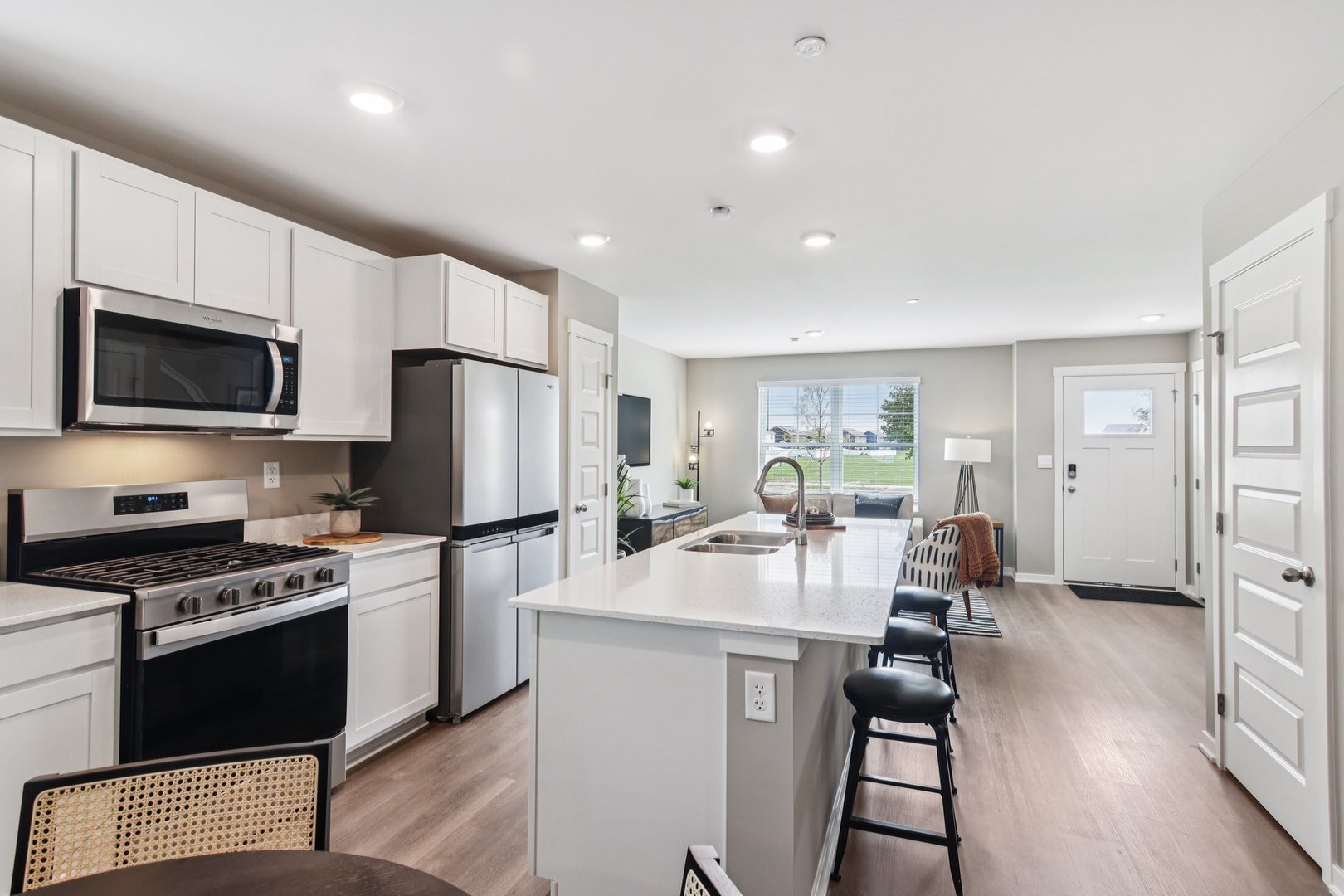 2253 Riesling Road Oswego, IL 60543 - Photo 7 of 27 a kitchen with sink a refrigerator and chairs