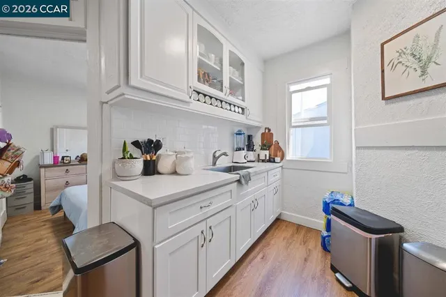 a kitchen with a sink cabinets and wooden floor