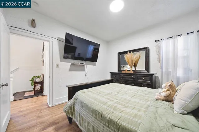a bedroom with a bed and a flat screen tv