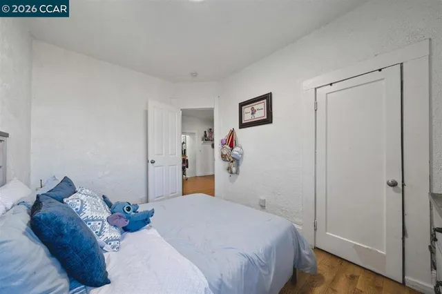 a bedroom with a bed and the view of bathroom