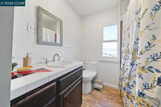 a bathroom with a sink toilet and window