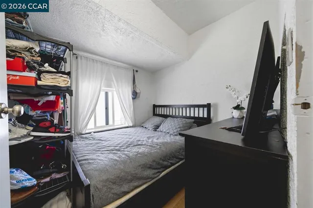 a bedroom with a bed and a window