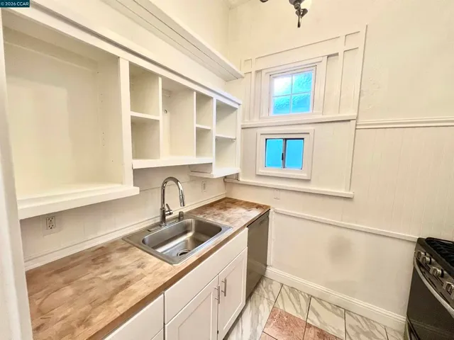a kitchen with a sink and cabinets