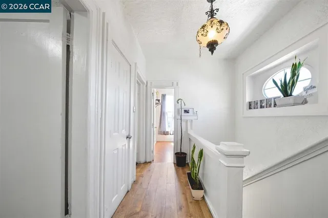 a view of a hallway to a livingroom with furniture