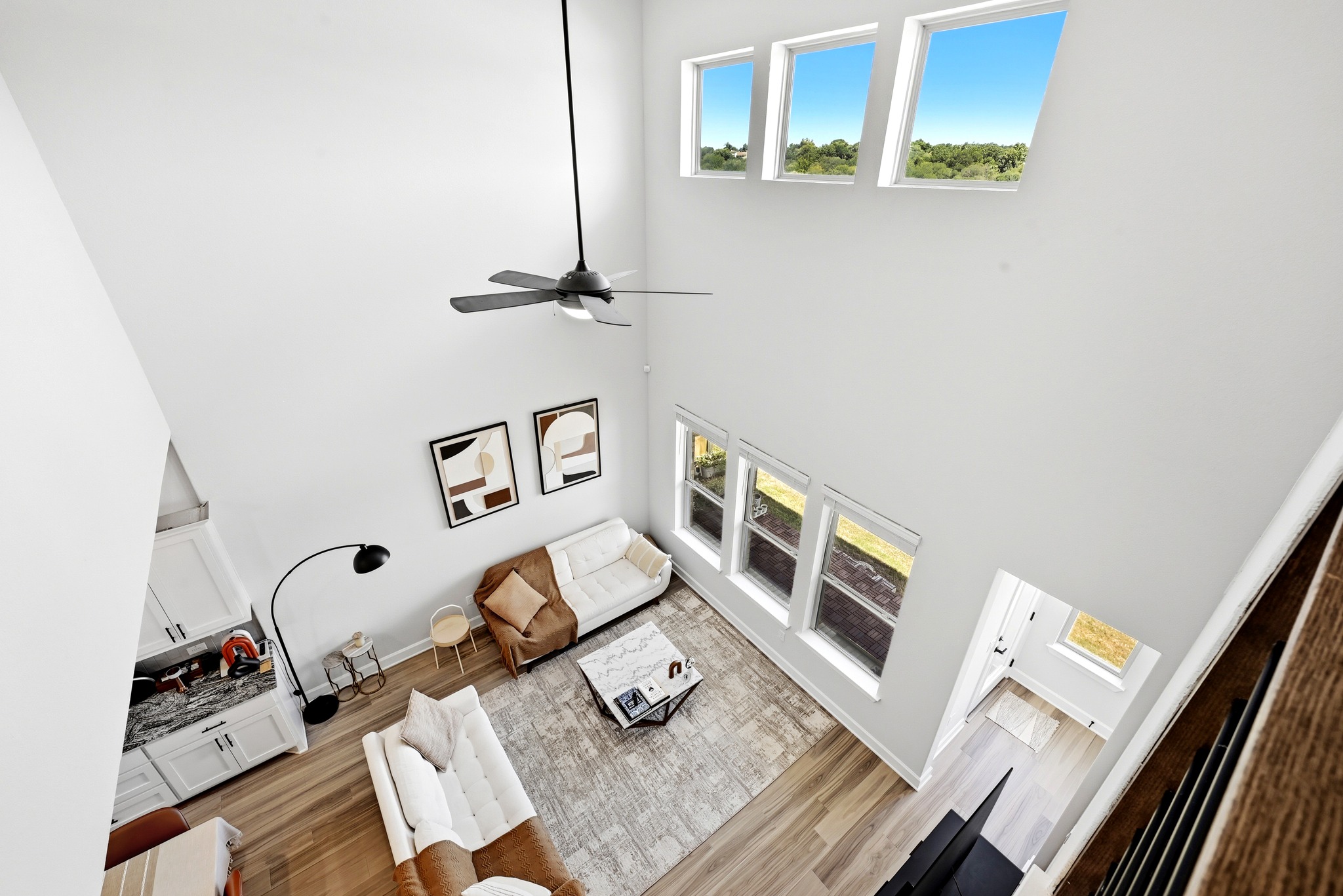 2702 Sebring Circle Austin, TX 78747 - Photo 25 of 35 Double-height ceilings and tall windows illuminate this modern open-concept living space.