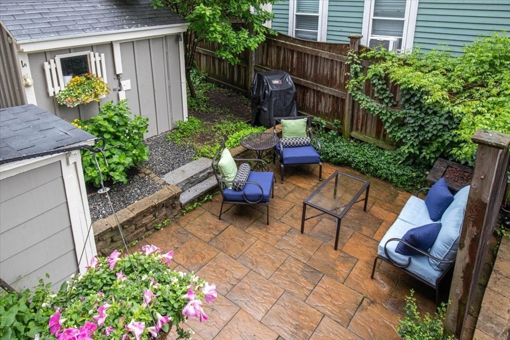 265 Sutton Street North Andover, MA 01845 - Photo 13 of 27 a view of a chair and table in the back yard of the house