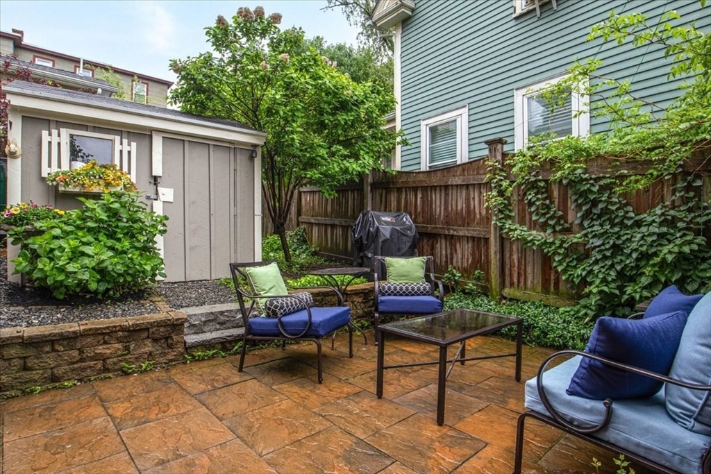 265 Sutton Street North Andover, MA 01845 - Photo 14 of 27 a backyard of a house with outdoor seating