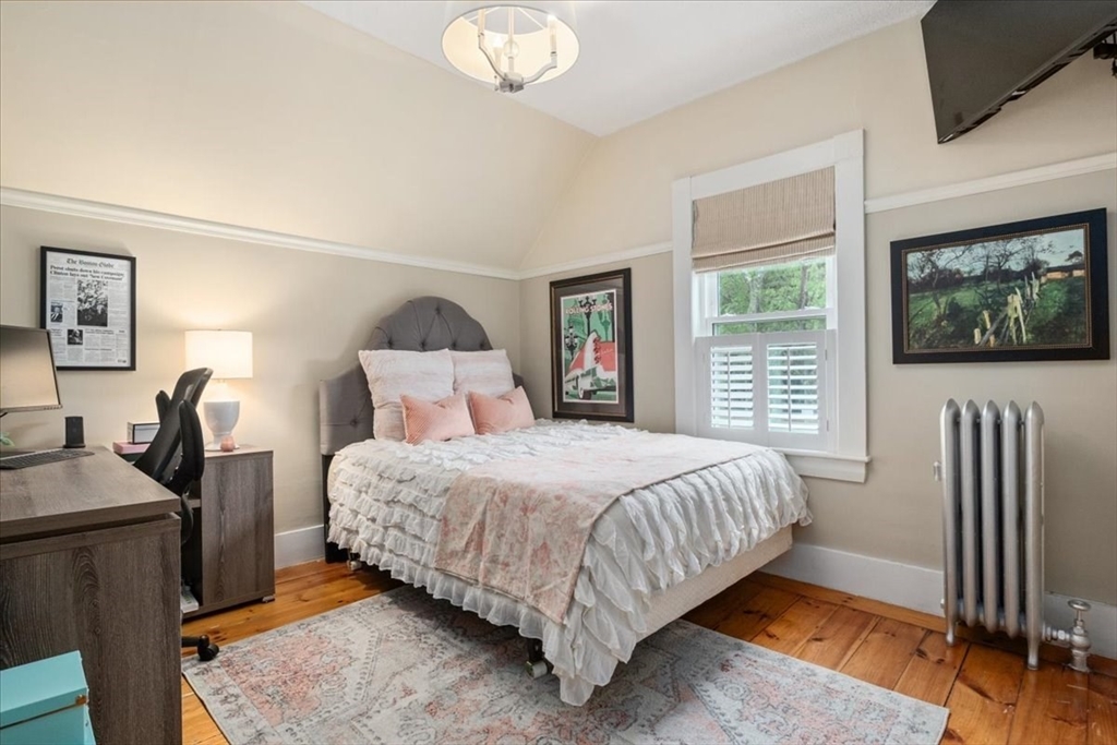 265 Sutton Street North Andover, MA 01845 - Photo 16 of 27 a bedroom with a bed a flat screen tv and dresser
