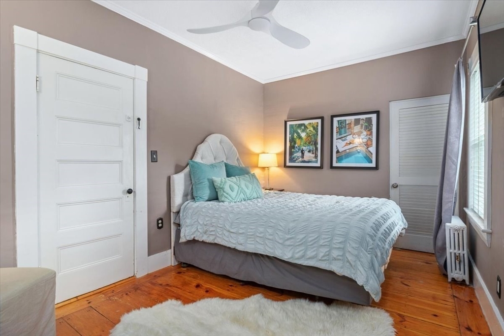 265 Sutton Street North Andover, MA 01845 - Photo 19 of 27 a bedroom with a bed and a dresser