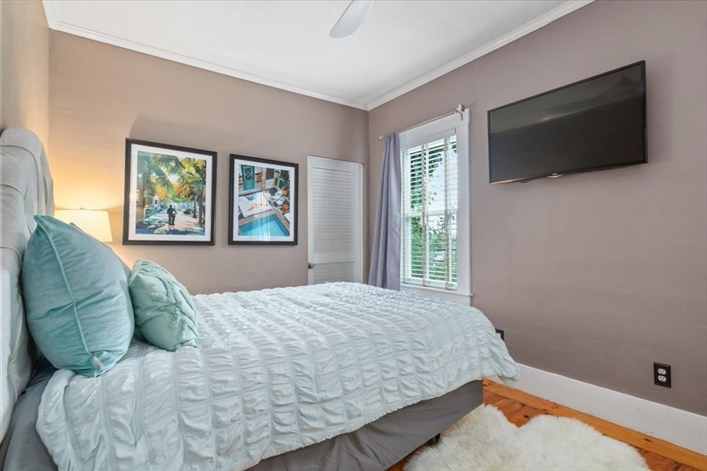 265 Sutton Street North Andover, MA 01845 - Photo 20 of 27 a bedroom with a bed and a flat screen tv